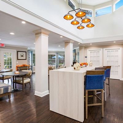 Leasing office furnished with 3 seperate seating areas each with tables and chairs at Azure Cove in Garden City, GA
